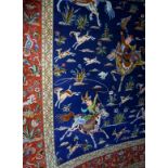 A superb silk Ghom rug with central blue field depicting hunter's on horse back with deer,