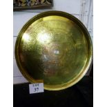 A large middle Eastern engraved brass circular tray est: £30-£50 (E)