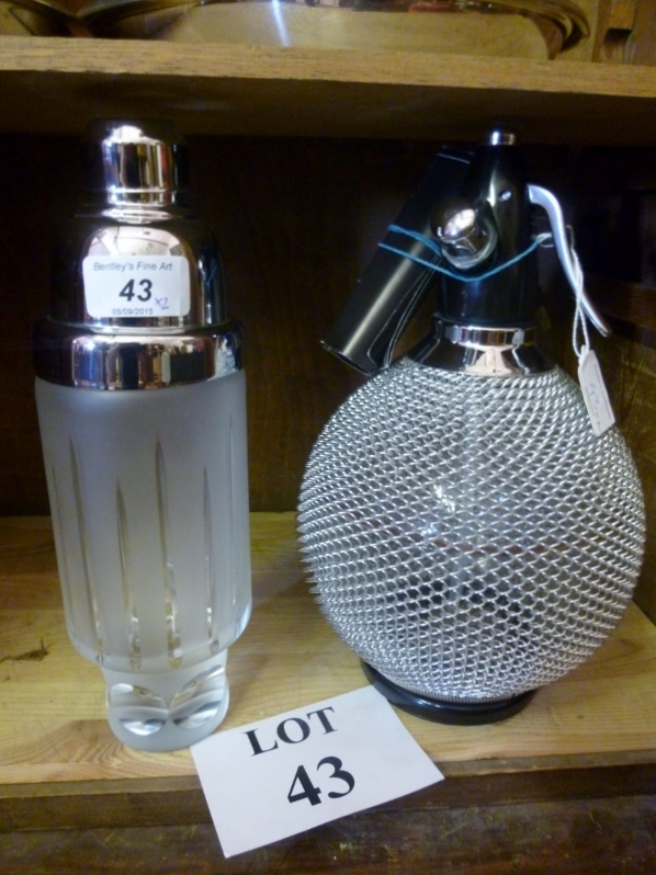 A frosted glass and chrome cocktail shaker and a soda siphon est: £30-£50 (D1)