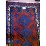 A Persian rug on blue ground (200 x 134 cm approx) est: £55-£85