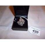 An 18ct white gold signed designer ring inset with diamonds in a floral design (size P) boxed est: