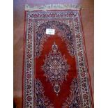 A late 20c runner on red ground (245 x 70 cm approx) est: £20-£40