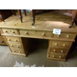 A pine pedestal writing desk with nine drawers est: £80-£120