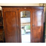 A Victorian mahogany triple wardrobe with hanging space to the left and the right side linen slides