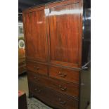 A George III mahogany linen press with double doors (later shelves) over two short and two long