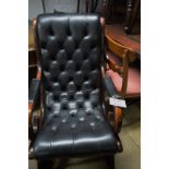 A fine mahogany framed rocking chair with deep buttoned black leather est: £200-£300