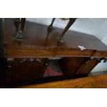 A Victorian mahogany pedestal sideboard with three blind drawers over end carved cupboards est: