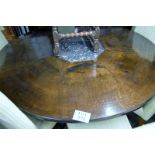 A large 20c oak round segment table with an octagonal centre marble section over a column base
