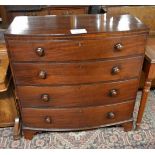 A George III mahogany bow fronted chest of four long drawers with turned handles and bracket feet