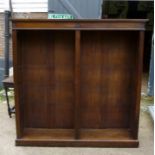 A large oak open bookcase with centre bar and adjustable shelves either side est: £200-£400