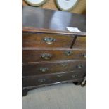 A Georgian oak chest of two short over three long drawers with brass handles and escutcheons est: