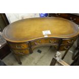 A mahogany oak linen kidney desk c1900 tan leather top est: £350-£450