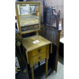 A late Victorian oak gentleman's shaving stand with swing mirror over two drawers and turned legs