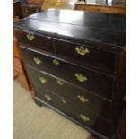 A large Georgian oak chest of two short over three long drawers with brass handles est: £150-£200