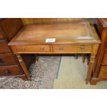 A fine 19c mahogany writing table with a tan tooled leather top over two drawers and turned legs