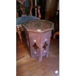 A carved folding Indian table inlaid with mother of pearl est: £30-£50