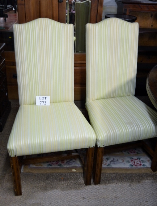 A 20c set of eight oak framed dining chairs with high backs and upholstered in pale green stripe