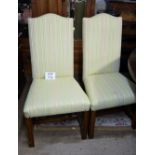 A 20c set of eight oak framed dining chairs with high backs and upholstered in pale green stripe