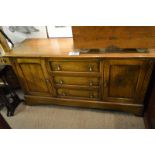 A late 20c solid oak sideboard with three central drawers,