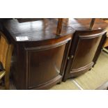 A large pair of early 20c mahogany bow fronted cabinets each with a panelled door est: £80-£120