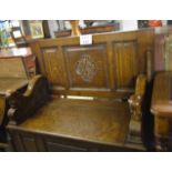 A 20c oak heavy monk's bench with a fold over table top and a lift up seat est: £200-£400