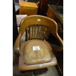 An early 20c oak swivel desk chair with tan leather seat est: £90-£120