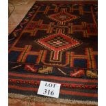 A blue and red Persian Balochi rug (80 x 132 cm approx) est: £40-£60