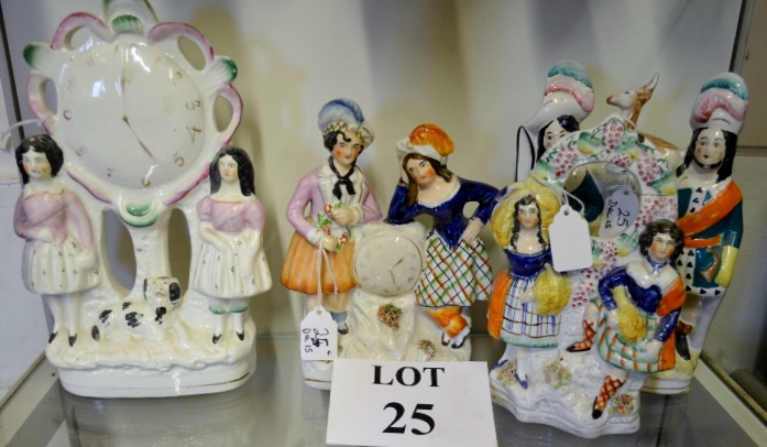 A Staffordshire figural flat back group with clock supported by two children with dog;