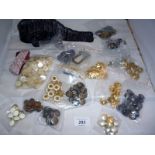 A large collection of buttons to include a bag of mother of pearl buttons and two rolls of