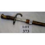 A WWI bayonet in metal scabbard est: £30-£50