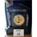 A late Victorian black slate and marble mantle clock of architectural form the dial inscribed