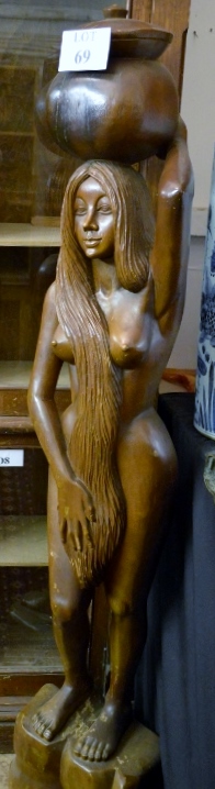 A very large carved figure of a woman carrying a water pot est: £150-£250 (F)