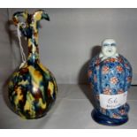 A small jug, small figurine and a Buddha