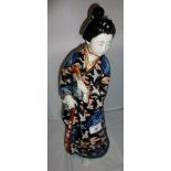 A large Japanese Famille Noir figure (a/