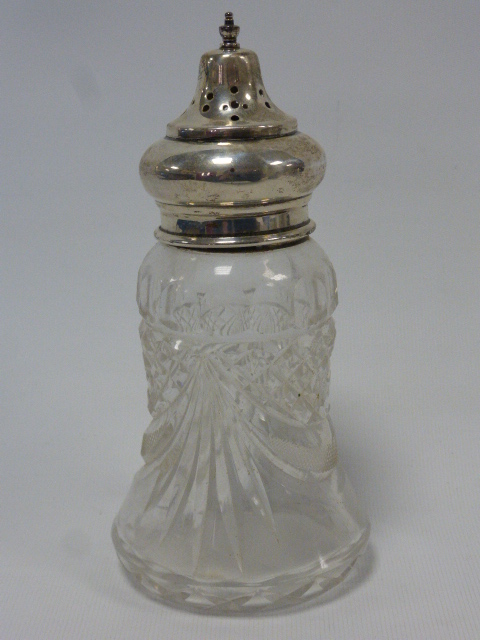 A cut glass and silver mounted muffineer