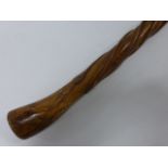 Walking cane carved from a single piece