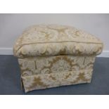 An upholstered footstool, with gold broc