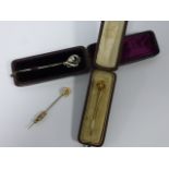 A 15ct gold Pearl set stick pin together