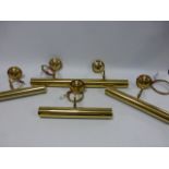 Four polished brass picture wall lights
