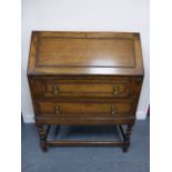 An oak bureau with fall front and fitted