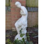 Garden statue of a semi clad maiden clutching her bosom,