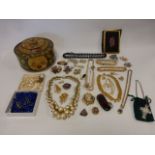 A tin of vintage costume jewellery to include a Waterford Crystal necklace, Monet necklace,