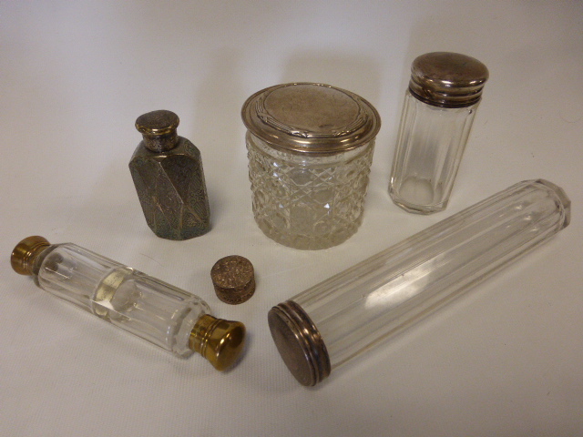 Three silver topped toiletry bottles hallmarked London 1883,  London (rubbed) and Birmingham 1906,