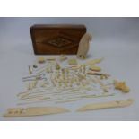 A collection of carved Ivory including numerous small objects and a 10cm standing Eagle