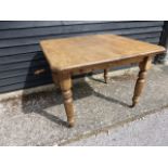 A Victorian pine kitchen table with canted corners, winder and extra leaf,