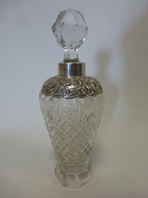 An elegant Edwardian silver collared cut glass scent bottle of tapering form on octagonal base,