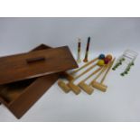 A 1930's table top croquet set complete with two pegs, six hoops, four balls,