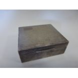 Silver cigarette box hallmarked Birmingham 1938 by F.H. Adams and Holman, 8.5x7.5x3.