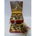 Collection of costume/fashion jewellery in red Estee Lauder case