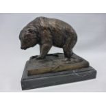 A bronze statue of a wild bear with raised front paw, with impressed name J.